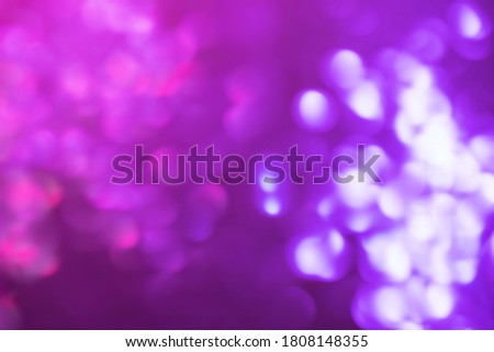 Defocused lights colorful bokeh on black background for celebration design. Abstract blurry backdrop for your design. Modern bright holiday background.