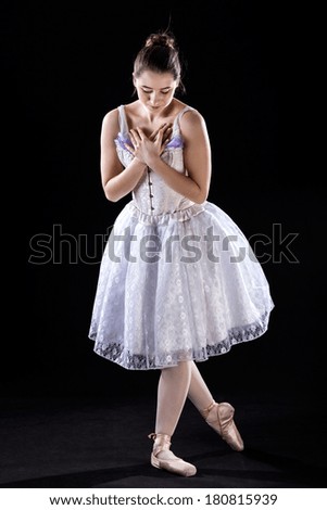 A ballerina making a bow after her dance performance