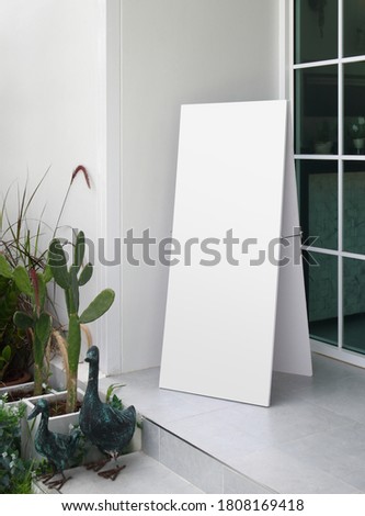 blank white advertising stand on entrance of coffee shop / background with space for text or image
