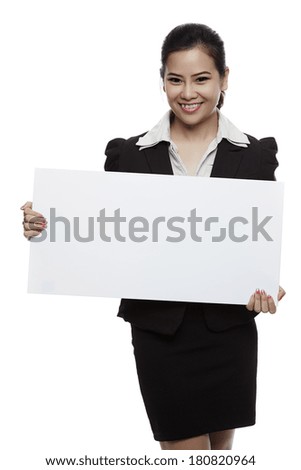Asian business woman holding blank whiteboard sign - Casual business woman in suit is holding blank billboard placard and showing its empty copy-space - Isolated on white background.