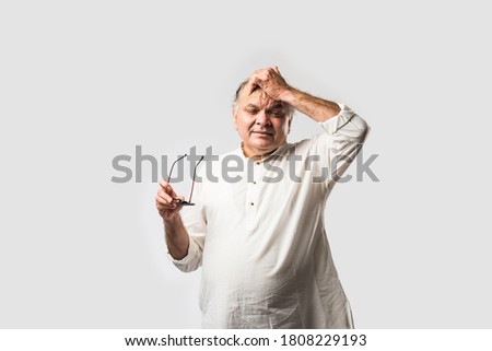 Indian asian old man having pain or ache in different body parts, sad expressions Royalty-Free Stock Photo #1808229193