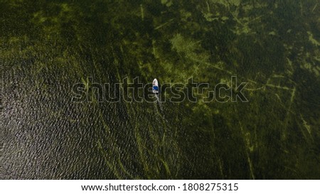 Aerial image of motorboat floating in Black sea water. The sandy bottom through the clear water. Ukraine