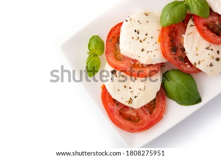 Traditional caprese salad with tomato and mozzarella cheese isolated on white background 