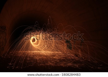 Lightpainting, circle made of fire in a tunnel