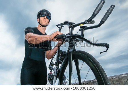 Man participating in triathlon with bicycle in mountain area Royalty-Free Stock Photo #1808301250
