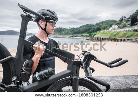 Man participating in triathlon with bicycle in mountain area Royalty-Free Stock Photo #1808301253