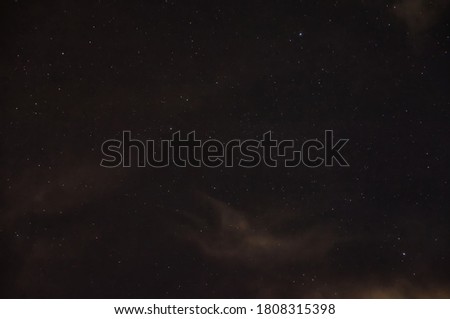 A Starry Night Sky with some Clouds