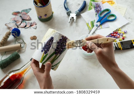 Decorating tin cans with decoupage napkins with using various decor elements. Do it yourself. Step by step. Step 9. Final. Coating with a colorless varnish. There is no waste. Other uses of packaging. Royalty-Free Stock Photo #1808329459