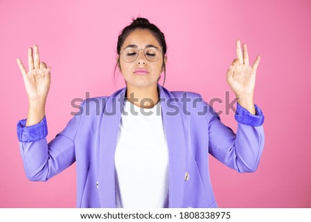 Young beautiful business woman over isolated pink background relax and smiling with eyes closed doing meditation gesture with fingers