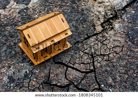Lonely building on the road in the cracks of an earthquake. Concept of risk insurance in the event of an earthquake. Royalty-Free Stock Photo #1808345101
