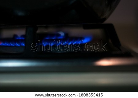 stove with blue fire and wok  