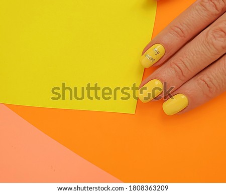 female hand beautiful manicure on a colored background