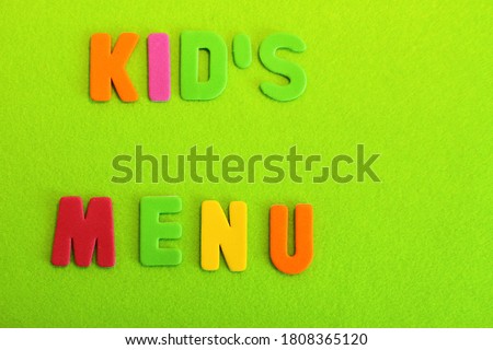 Kid's menu lettering, multicolored letters on color background, yellow green orange colors 