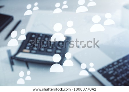 Double exposure of social network icons hologram on calculator and pc background. Networking concept