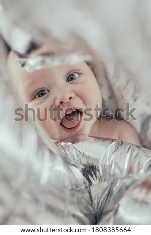 
Smiling baby with silver balloon