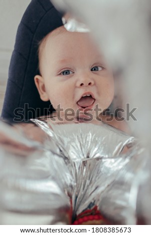 
Smiling baby with silver balloon
