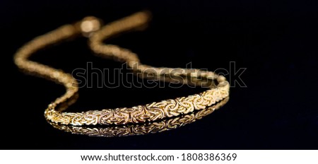 Gold chain jewellery. Gold chain on black bacground