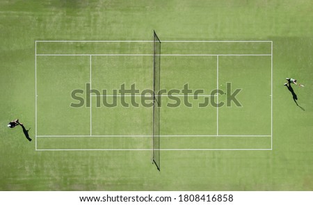 aerial view of two tennis players on an artificial grass court during a championship Royalty-Free Stock Photo #1808416858