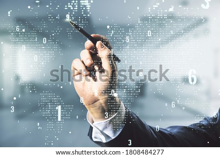 Multi exposure of developer's hand with pen working with abstract software development hologram and world map on blurred office background, global research and analytics concept