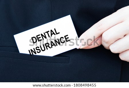 The girl holds a card with the inscription DENTAL INSURANCE.