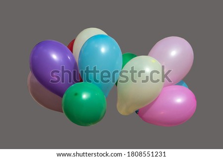 Colorful air balloons isolated on a grey background.
