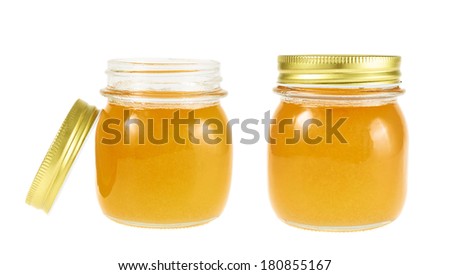 Closed and opened jar of honey isolated over the white background