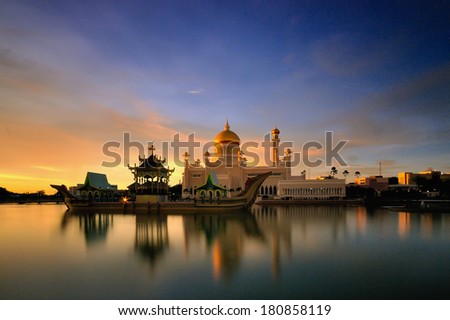 Beautiful mosque with golden dome and ship monument in long exposure during sunset Royalty-Free Stock Photo #180858119