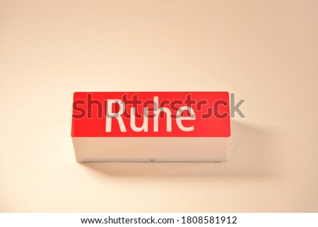 Quiet sign - word Ruhe. sign light box. angle view of icon information lamp, light with the text Ruhe. geman language word - RUHE - Quiet - Wall sign over a entry of a meetingroom
