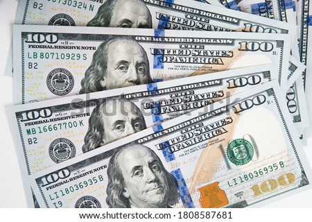 Close-up of one hundred dollar bills on a white background. American money.