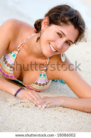 happy beach girl relaxing at the beach smiling