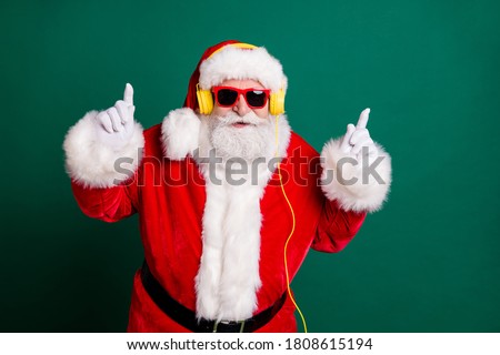 Portrait of his he nice attractive handsome cheery cool funny Santa father listening pop music bass single melody hit having fun rhythm party isolated over green color background