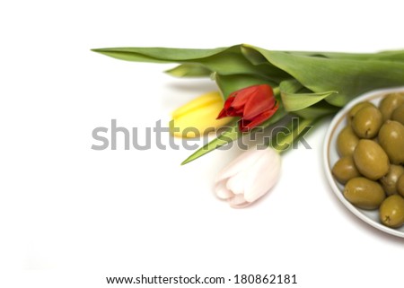 Colored tulips and green olives. Photo.