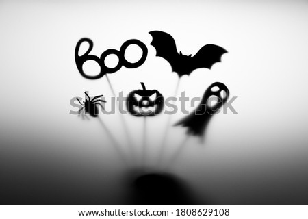 Halloween Decoration. Terrifying Shadow Puppets. Shadows pumpkin, bat, ghost, spider, and Boo word on the gray background.