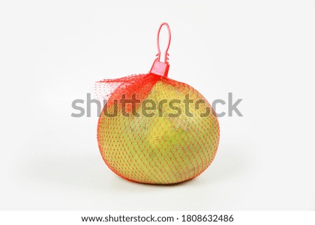 Pomelo with nylon net isolate in white background.
