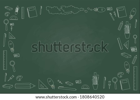 blackboard written icon about school and learning written by colorful chalk a.The board around with school equipment like pen,  paper clip, pencil, eraser.