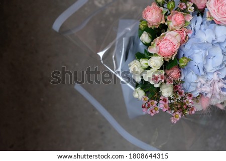 bouquet with roses and blue hydrangea on a concrete background