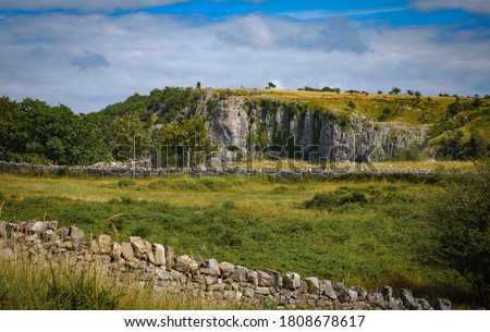 Cliffs of Cheddar Gorge from high viewpoint. High limestone cliffs in canyon in Mendip Hills in Somerset, England, UK Royalty-Free Stock Photo #1808678617