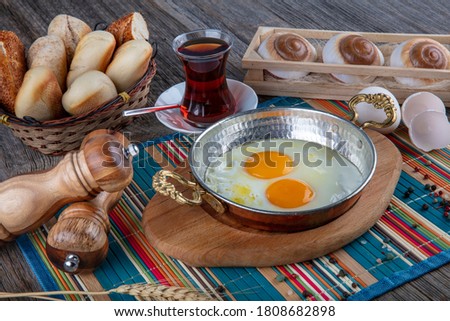 Turkish breakfast, Turkish style eye egg on copper field. Butter and eggs in copper pan. Royalty-Free Stock Photo #1808682898