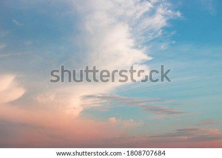 Evening blue and pink sky with unusual mystical or dramatic clouds. Cloudscape background.