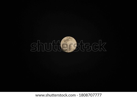 The moon shines in the middle of the dark