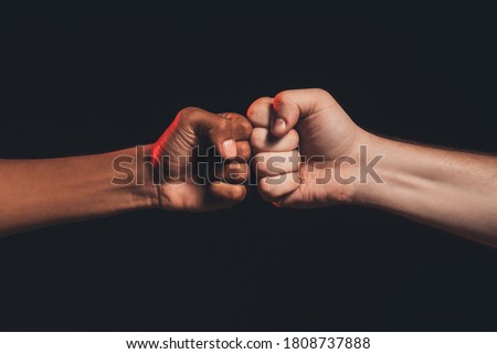 Black lives matter. Races fights. African caucasian male fists bumping isolated on dark copy space. Ethnic conflict. Human harassment. No racism Royalty-Free Stock Photo #1808737888