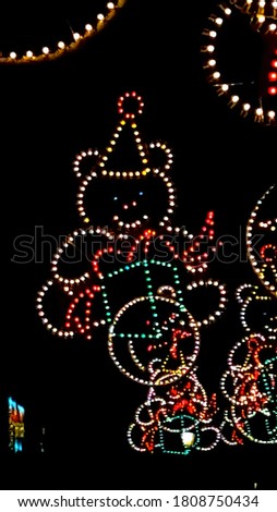 Christmas lighting hanging in night city with colorful lights