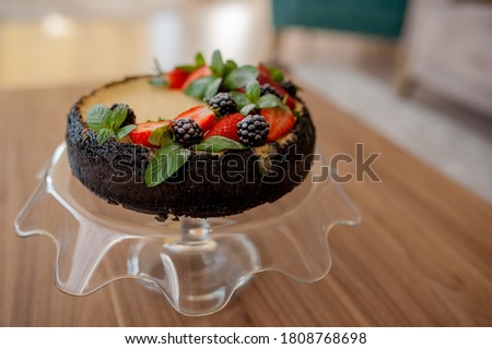 Beautiful and delicious birthday cake on the wooden table. Picture with selective focus and toning