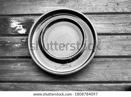 ceramic round base on a wooden floor in black and white
