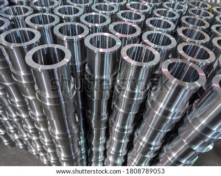 abstract industrial shiny steel production stack background with cnc machined pipes - selective focus and lens blur technique