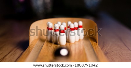 Bowling game indoors with pins or skittles