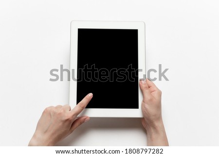 Close up of human hands using tablet with blank black screen