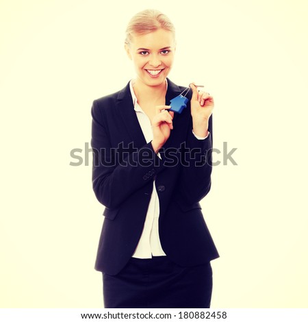 Young businesswoman holding house shaped key chain