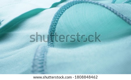 Super close up. elements of a gentle blue blouse with frills. textile background.