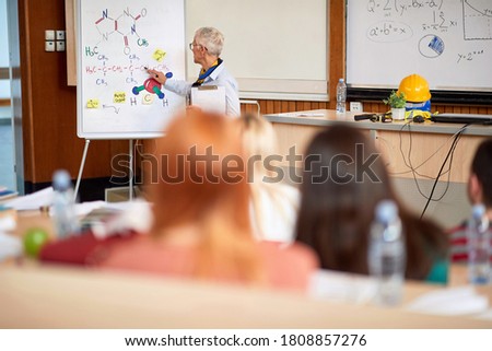 Professor giving lecture in chemistry in amphitheater